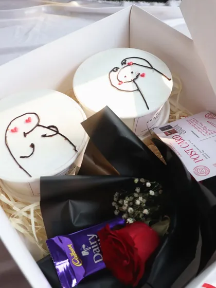A different angle of the "XOXO" hamper, showing the postcard and chocolate bar included.