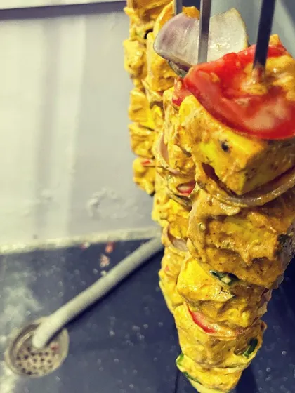 Here’s a look at our Punjabi-style paneer tikka, marinated in a flavourful blend of spices and yogurt before being cooked. The chunks of paneer, onion, and tomato are ready for the tandoor.