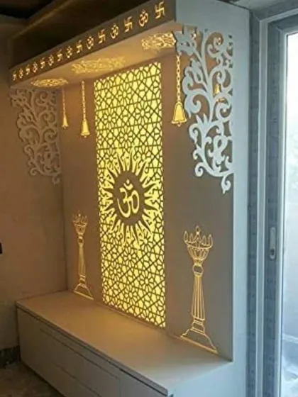 A beautiful mandir design featuring a backlit jali panel with the "Om" symbol at its center. The design incorporates traditional elements like hanging bells and diyas, all crafted with modern precision and materials for a clean, elegant look.