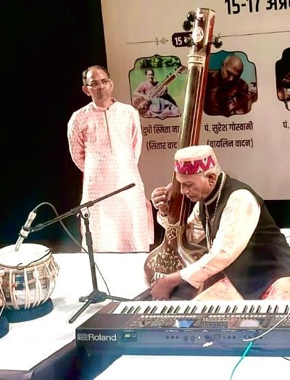 A moment during the concert in Jaipur with Pt. Vijay Chandra Ji, who is playing a stringed instrument while I provide the rhythmic accompaniment.