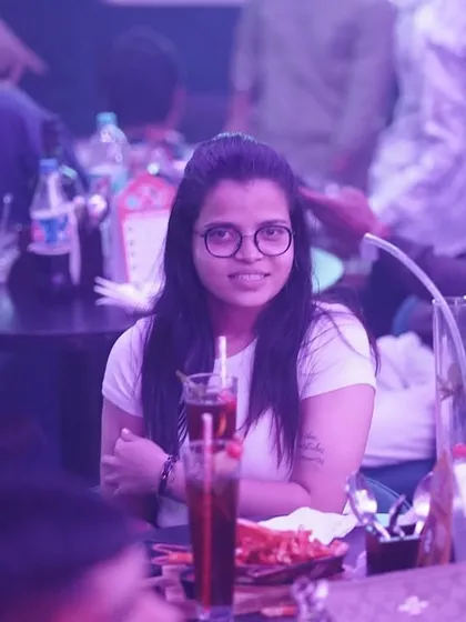 A candid shot of someone enjoying the vibe at their table. It's not just about the dance floor, but the whole atmosphere.
