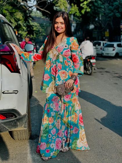 A beautiful floral sharara set perfect for daytime festivities. The vibrant colors and flowing silhouette make it a fun and photogenic choice.