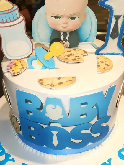 Who's the boss? This "Baby Boss" themed cake is perfect for a little one's first birthday. It's decorated with the iconic character, a milk bottle, and other fun elements from the movie.