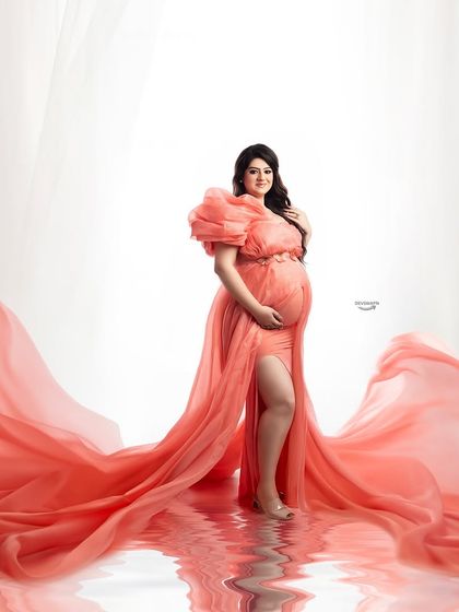 This shot captures the full splendor of the coral-pink flowing gown, complete with a water reflection effect. It's a perfect example of the glamorous, high-impact portraits I love to create.