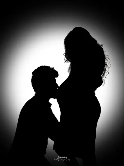 A dramatic silhouette captures the profound connection between partners. In this black and white portrait, the focus is purely on the emotion and the beautiful shape of new life, a powerful memory for you to hold onto.