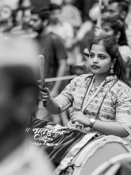 A black and white version of the focused dhol player, the monochrome effect adding a timeless, documentary feel to the shot.