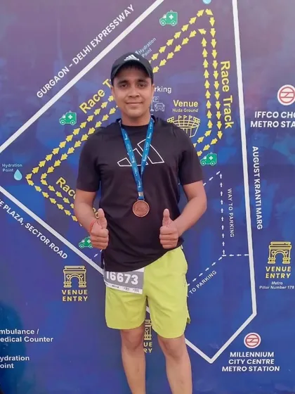 Proudly wearing my medal in front of the race track map. Every race is a new challenge and a new opportunity to prove your hard work.
