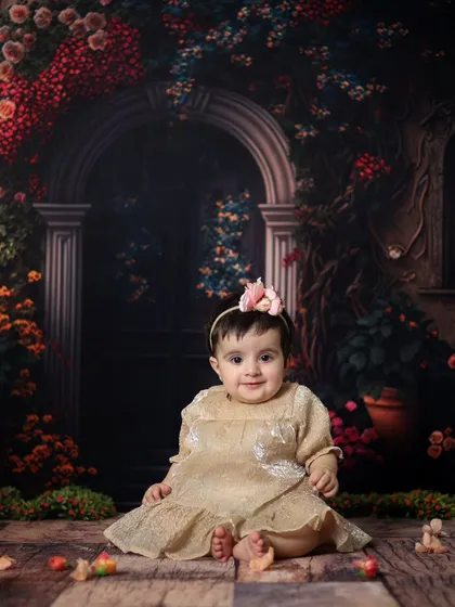 A beautiful seated portrait against a floral backdrop. Her sweet smile and direct gaze make this a timeless photo.
