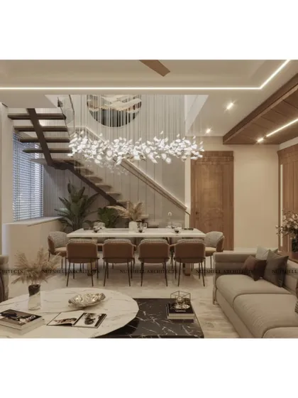 We believe luxury is about volume and light. This view showcases a double-height living and dining area, where a sculptural staircase appears to float alongside a magnificent chandelier. The open plan design, combined with warm, integrated LED lighting and natural wood accents, creates an environment that is both grand and intimately welcoming.