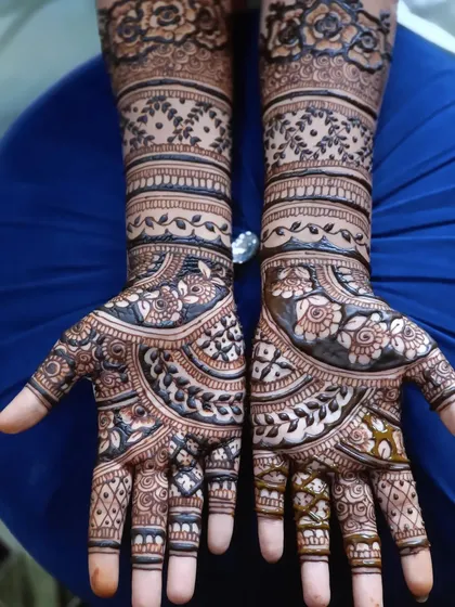 A clear, top-down view of a complete bridal mehendi design, showing the beautiful symmetry and intricate details.