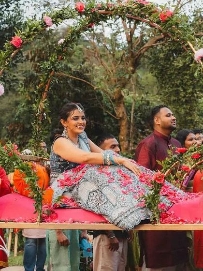 A bride's entry should be nothing short of royal. We designed this beautiful floral palanquin (doli) for Supreetha, allowing her to make a grand and graceful entrance, feeling like a true princess on her special day.