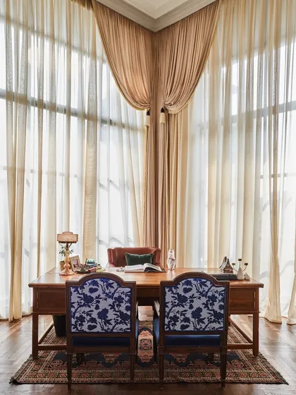 Every piece in this cabin tells a story. The desk is an 8 foot antique, while the main chair is the founder's very first one from our initial project together. I blended these sentimental items with vintage visitor chairs and a rare pink glass lamp to create a space that feels both personal and timeless.