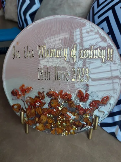 This memorial plaque was created to honor a loved one. The client wanted something simple and elegant to remember a special person. I used preserved flowers to create a beautiful tribute with the message "In the Memory of century".