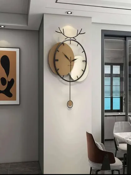 We combine modern art with functionality in this unique pendulum wall clock. Featuring a striking deer antler motif and contrasting metallic discs, it serves as both a reliable timepiece and a captivating piece of wall sculpture for any contemporary home.