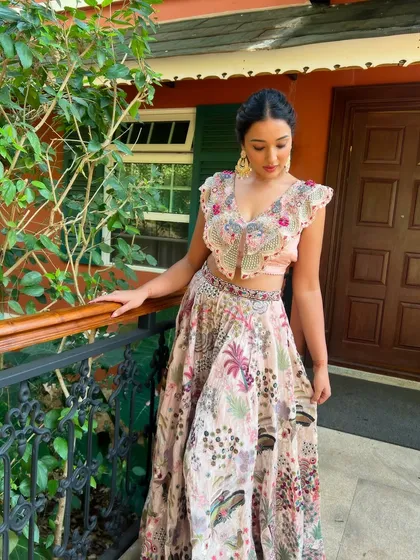 The client looking stunning in her floral lehenga, her hair styled in a beautiful textured ponytail.