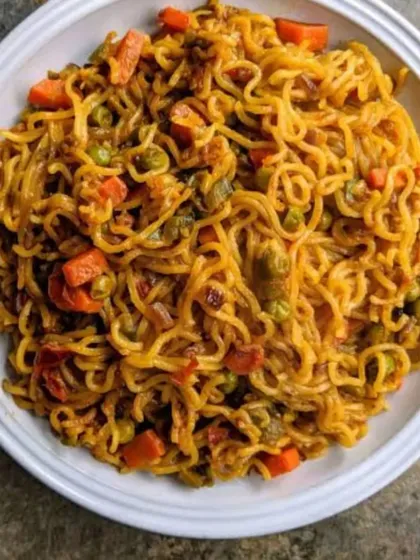 A bowl of my special street-style Maggi, cooked with chopped carrots, peas, and a blend of spices to elevate the classic instant noodles. It's the ultimate comfort food for any time of the day or night.