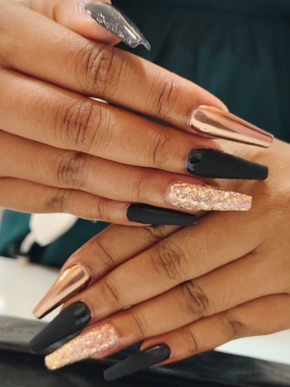 A bold and luxurious set of long coffin nails. I combined matte black, rose gold chrome, and a chunky rose gold glitter for a high-contrast, textured look.
