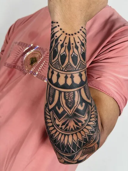 A close-up of the mandala forearm sleeve, highlighting the clean lines and solid black fill of the intricate patterns.