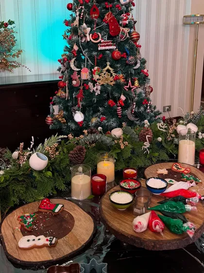 A DIY cookie decorating setup for a Christmas party. I provide the freshly baked cookies, colorful icing, and sprinkles so everyone can get creative.