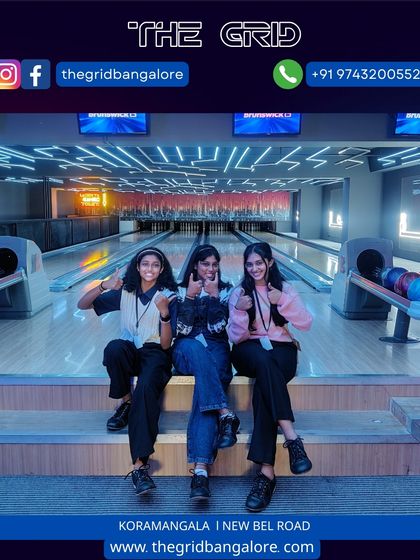 A group of girls giving a thumbs up at our bowling alley.