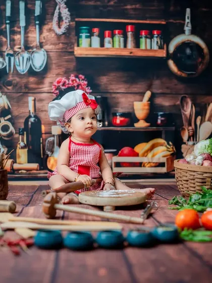 A moment of quiet contemplation with a tiny rolling pin. This shot showcases the detailed setup of the kitchen theme, from the spice rack in the background to the scattered flour on the floor.