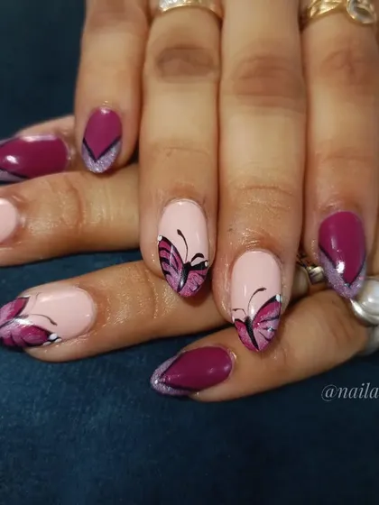 A creative butterfly-wing inspired French manicure in a beautiful magenta shade.