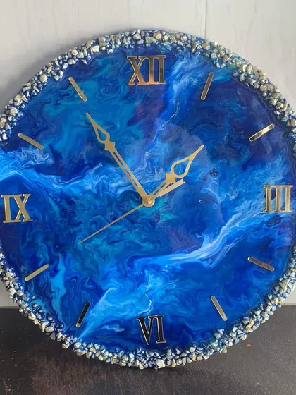 This deep blue resin clock has a mesmerizing, galaxy-like feel, with a full border of sparkling crystals.