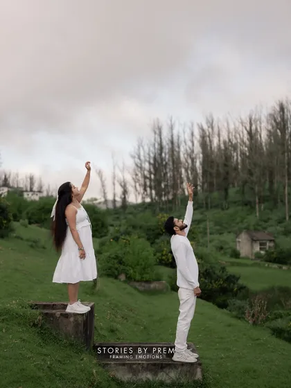 A whimsical shot of the couple reaching for the sky in the beautiful Ooty landscape. This photo captures a sense of freedom, hope, and the start of a new journey together.
