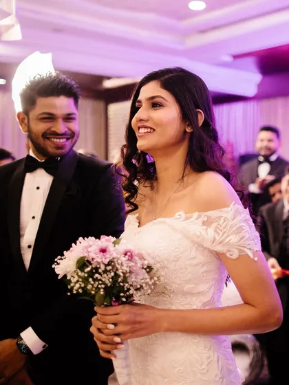 A beautiful shot of a couple at their reception. The bride wears a stunning white gown with a classic smokey eye, a timeless look for a modern wedding.