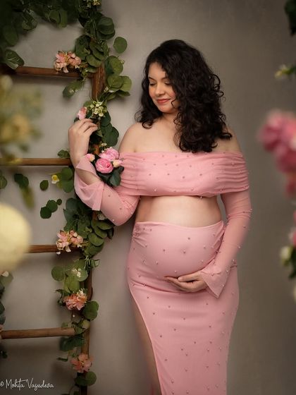 Leaning against a floral ladder, this pose in a soft pink two-piece is both romantic and modern.