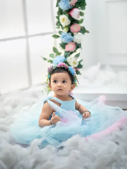 Lost in a sea of clouds. This shot highlights the dreamy and ethereal quality of our floral fairy setup, making your baby look like a true angel.