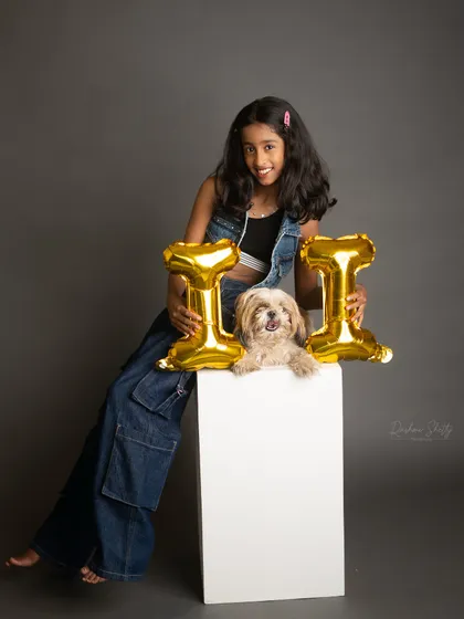 Celebrating eleven with her furry friend. The contrast of the metallic balloons and the monochrome photo creates a modern and fun birthday portrait.