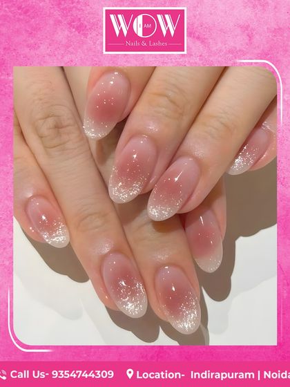 A soft and dreamy look featuring long, oval extensions with a glittery ombré effect. The subtle fade from a natural base to sparkling tips is perfect for a touch of everyday magic.