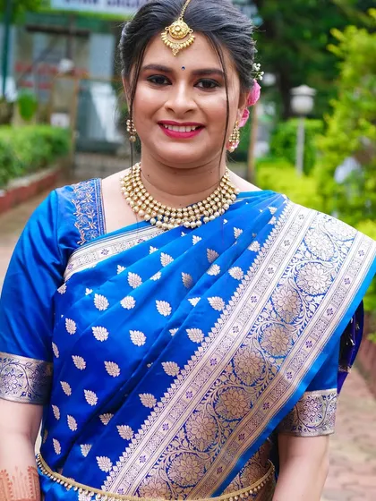 A beautiful outdoor shot of Rohini. The natural light shows off the flawless HD makeup finish.