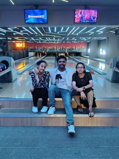 A group of friends relaxing and posing for a photo at our bowling alley.