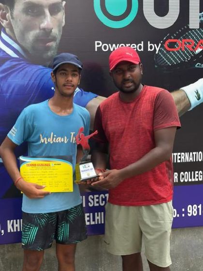 Raunak Gilra holds his trophy after winning the U18 boys' title at a UTR tournament. This win adds to the impressive list of achievements by our academy's players.