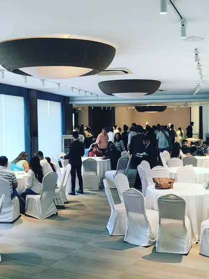 We can cater in any venue, transforming it for a premium dining experience. This wide shot shows the guest seating arrangement at the Fast&Up corporate event, managed entirely by our team.