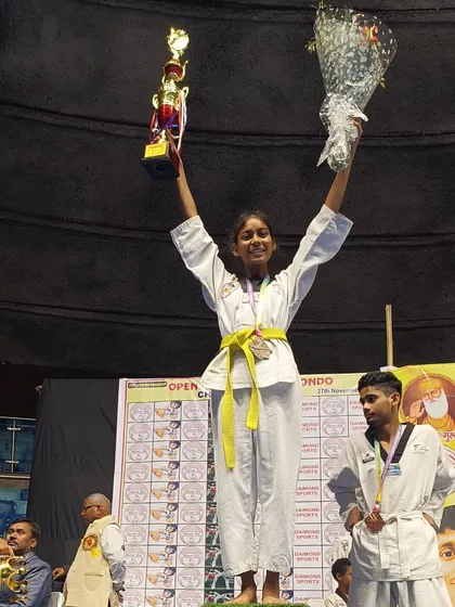 Another one of our champions celebrating her victory on the podium at the Open National Taekwondo Championship.