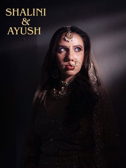 A dramatic, high-contrast portrait of the bride. The play of shadow and light highlights her features and traditional jewelry.