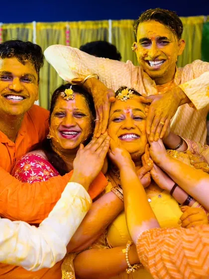 Haldi ceremonies are all about joyful chaos, and I am here for it. This moment, with everyone piling on the love (and haldi) for Neha, is pure, unfiltered happiness. I love capturing the energy when family and friends just let go and have fun.
