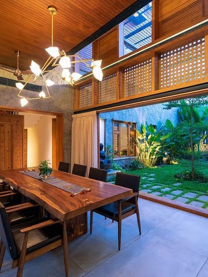 We believe in blurring the lines between indoors and outdoors. This dining area opens completely to a central courtyard garden, creating a seamless flow and allowing the homeowners to enjoy the greenery and natural light from within their home.