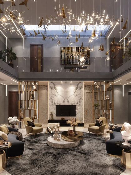 This angle of the Agra residence's living room highlights the double-height volume and the skylight that bathes the space in natural light. The suspended art installation and curated furniture create a dynamic yet harmonious environment.