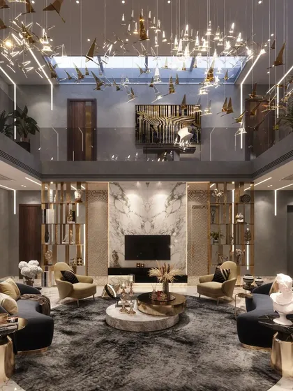 This angle of the Agra residence's living room highlights the double-height volume and the skylight that bathes the space in natural light. The suspended art installation and curated furniture create a dynamic yet harmonious environment.