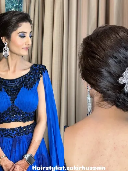 This modern and chic low bun is a versatile choice for any party or formal event. The clean lines and elegant twist are accented with a delicate butterfly clip, adding a touch of sparkle.