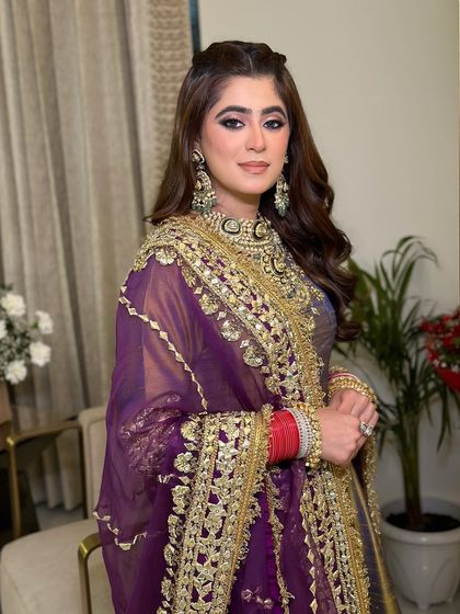 A closer look at the makeup, showing the intricate details of her jewelry and the beautiful blend of her eyeshadow. The look is glamorous and perfect for an evening celebration.