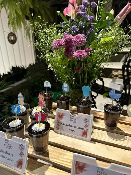 Themed desserts for a baby shower. We served blueberry cheesecake and chocolate mousse cups decorated with cute toppers like baby clothes and strollers to fit the celebration perfectly.