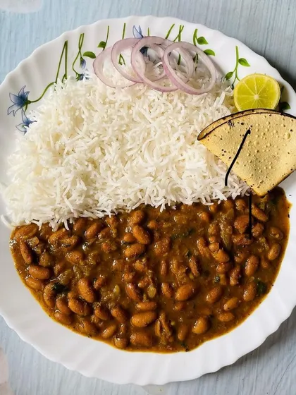 This is my homestyle Rajma Chawal, another popular choice for bulk vegetarian catering. The creamy rajma curry is cooked with simple spices and served with rice, papad, and onion, just like you would make at home.