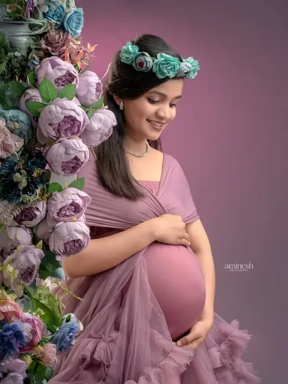 A close-up portrait that captures a gentle, loving expression. The soft lighting and floral details create a tender and intimate mood for this maternity photo.