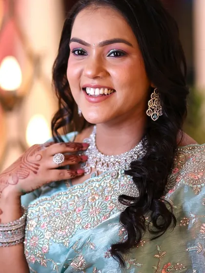A beautiful, bright smile from this wedding guest. The makeup enhances her features without looking heavy.