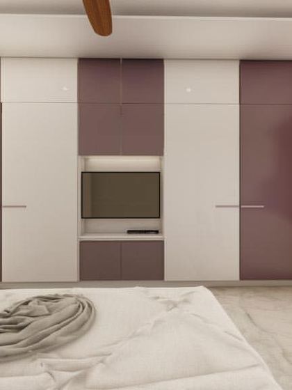 A bedroom with a simple and clean design, featuring a two-tone purple and white wardrobe with an integrated TV unit.